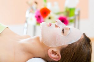 25774809 - wellness - woman receiving facial mask in spa for clean skin